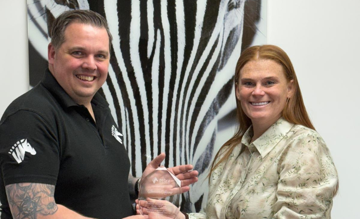 Brendon Harvey (l) being presented with a plaque to mark his promotion by managing director, Samantha Overton