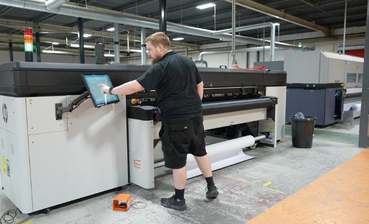 Ultima Displays' Graphics Operator, Michael Jones, operating the new HP Latex R2000